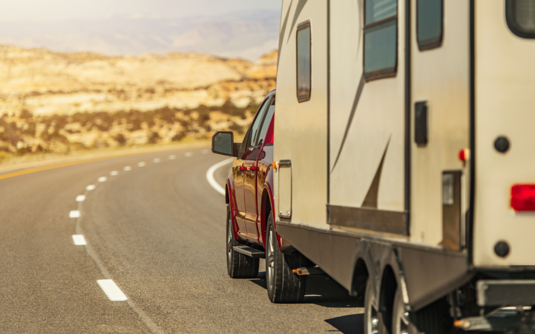 A scenic South Dakota highway with an RV traveling under a clear blue sky, symbolizing freedom and the perks of establishing residency.